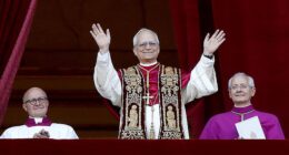 Pope Leo XIV appears on the balcony of St Peter¿s Basilica for the first time in a striking red mozzetta and gold-embroidered stole, a look Vogue later named his ¿best outfit of 2025¿
