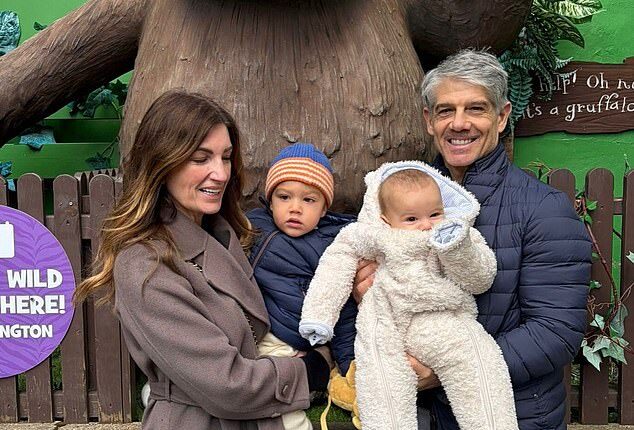 Baroness Karren Brady continued to show off her weight loss as she shared sweet family snaps to Instagram on Friday (pictured with her husband Paul and their grandchildren Leo and George)
