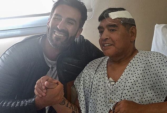 The late Diego Maradona (right) shakes hands with his doctor Leopoldo Luque, who has been charged, in Olivos, Buenos Aires province, Argentina, on November 11, 2020