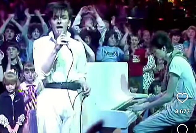 Ricky Gervais looked unrecognisable in a belted white jumpsuit in a throwback snap from his 1980s pop career