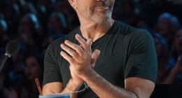 Simon Cowell has revealed why he is often seen wearing red-tinted glasses while filming