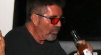 Simon Cowell was spotted swigging a beer with his partner Lauren Silverman in the back of a taxi as they headed home after the first Britain's Got Talent semi-final on Monday