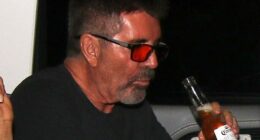 Simon Cowell was spotted swigging a beer with his partner Lauren Silverman in the back of a taxi as they headed home after the first Britain's Got Talent semi-final on Monday