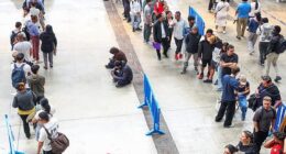 People queue to receive documentation in Hospitalet de Llobregat, near Barcelona, Spain