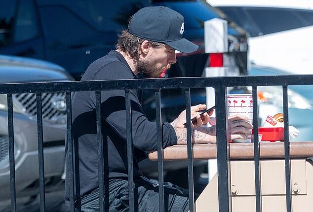 Brooklyn Beckham was spotted cutting a solitary figure while stepping out for fast food in Los Angeles on Sunday, while his estranged family lived it up in NYC