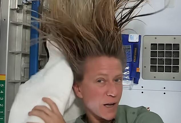 Astronaut Karen Nyberg demonstrates how she washes her hair while aboard the International Space Station