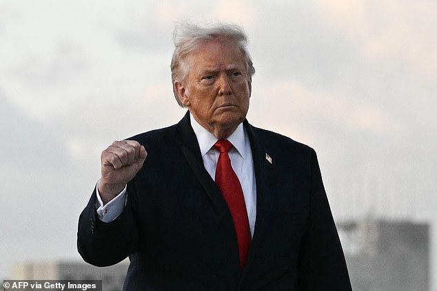 US President Donald Trump makes a fist upon arrival at Miami International Airport in Miami, on April 11, 2026