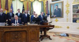 Travis Smith, 2, lies on the floor as President Donald Trump speaks during an event on health care affordability in the Oval Office at the White House, Thursday, April 23, 2026, in Washington