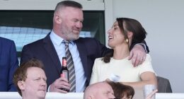The WAG, 40, put on a cosy display with her husband Wayne, 40, as they were spotted together in the crowd while sipping on a glass of fizz