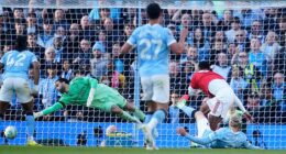 Erling Haaland slots the ball home for Manchester City's winner against Arsenal
