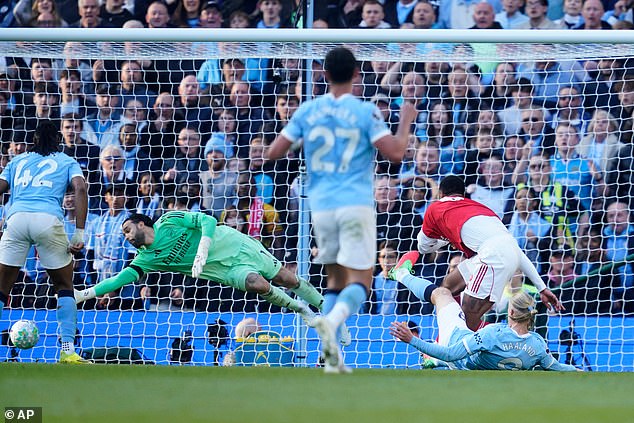 Erling Haaland slots the ball home for Manchester City's winner against Arsenal
