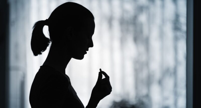 woman taking pill