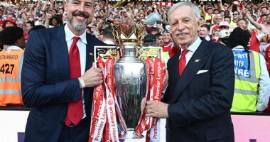 Arsenal co-chair Josh Kroenke celebrates winning the Premier League title with father Stan