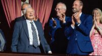 Beaming David Attenborough receives a standing ovation as he takes a seat beside Prince William at 100th birthday celebration with star-studded guests