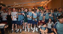 Arsenal's players watch Manchester City drop points on Tuesday night, handing them the Premier League title