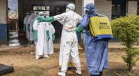 Former CDC director Dr Robert Redfield has warned that the Ebola outbreak in the DRC could become a 'very significant pandemic' (Workers are shown above being sprayed in the DRC)