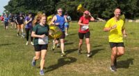 Darren Wood (right) during his 1,000th parkrun in Morden, south London, on Saturday as he became the first runner to reach the milestone