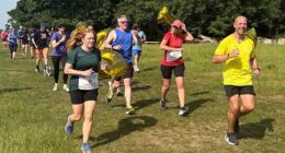 Darren Wood (right) during his 1,000th parkrun in Morden, south London, on Saturday as he became the first runner to reach the milestone