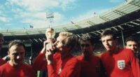 George Cohen, Bobby Moore (with trophy), Geoff Hurst and Martin Peters celebrate England's World Cup triumph at Wembley in 1966
