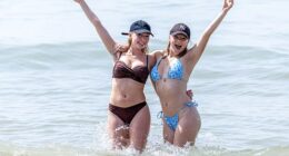 Sunseekers cool off in the sea off Brighton, East Sussex, on Saturday
