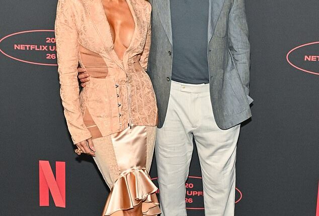 Jennifer Lopez shot Office Romance co-star Brett Goldstein the look of love on Wednesday as they flirted on the red carpet at the Netflix upfront event