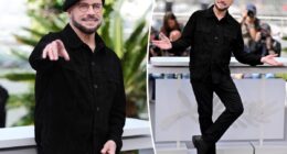 John Travolta models another beret at Cannes after being trolled for new look
