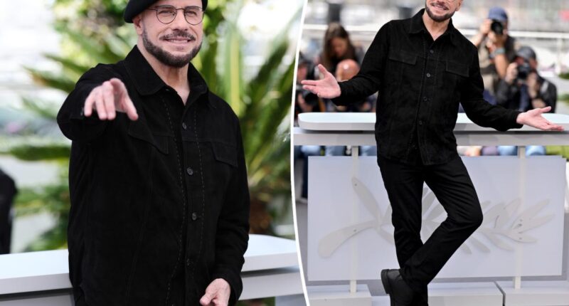 John Travolta models another beret at Cannes after being trolled for new look