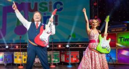 Mr Tumble with Samantha Dorrance performing on stage on the Time to Rock tour