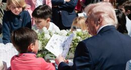 President Donald Trump is photographed as he tells a little boy at Monday's White House Easter Egg Roll how former President Joe Biden used an autopen to sign things