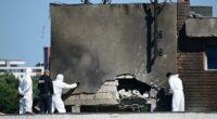Police and forensic investigators examine the location of impact after a Russian drone struck an apartment building in Galati, western Romania