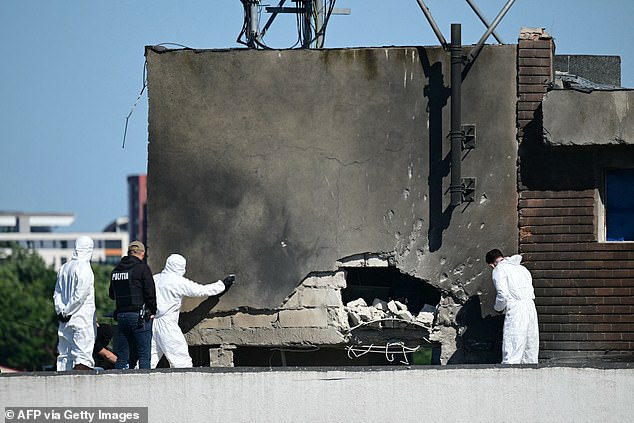 Police and forensic investigators examine the location of impact after a Russian drone struck an apartment building in Galati, western Romania
