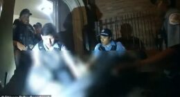 Three officers carried her out of the building by her arms and legs