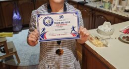 Hannah Teklic is seen proudly showing off her certificate for track and field champion on May 6, just hours before she suffered a rare brain bleed