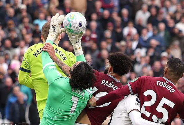 Arsenal goalkeeper David Raya is fouled in the build up to West Ham's 'goal' at the London Stadium on Sunday. The decision to disallow the strike has angered fans of other clubs