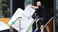 Removal men have begun taking Pep Guardiola's belongings out of his Manchester apartment