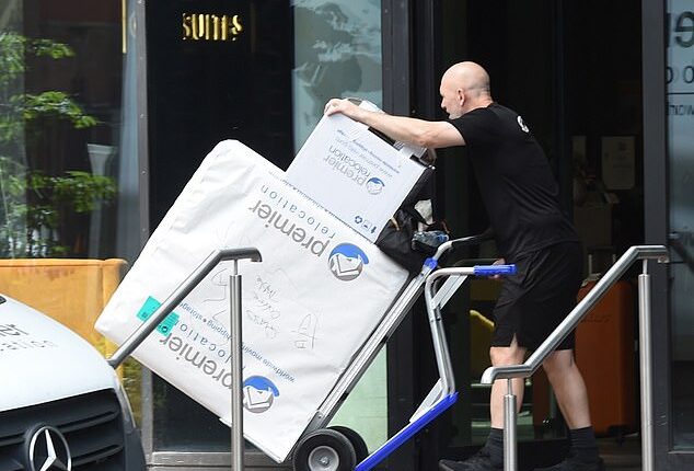 Removal men have begun taking Pep Guardiola's belongings out of his Manchester apartment