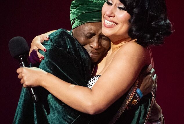 Pictured: Raye seen hugging her emotional grandmother Agatha Dawson as she wins Album of the Year at last night's BRIT Awards