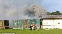 The fathers who were drinking in the club's beer garden climbed on top of the flaming container and helped him out through a small window after a mother heard him wailing