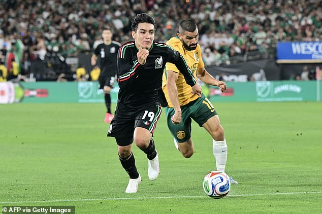 Mexico's Gilberto Mora beats Socceroo Aziz Behich to the ball in the Aussies' 1-0 loss in Los Angeles on Sunday