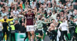 Socceroos star Cameron Devlin (centre) reacts after his Hearts side had a third goal scored on them by Celtic in the match that decided the Scottish Premiership title