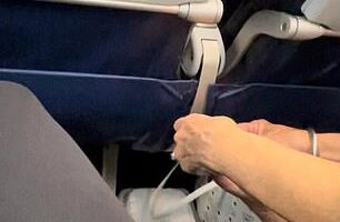 Pictures show the shameless passenger resting one foot on her opposite knee as she used both her hands to casually pick at her toes during a recent flight