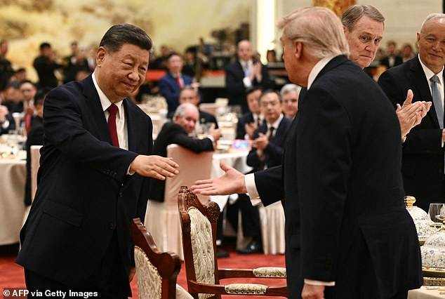 China's President Xi Jinping shakes hands with US President Donald Trump at a state banquet at the Great Hall of the People
