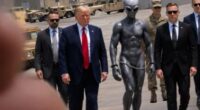 The President and bodyguards flank the handcuffed extra terrestrial at a US military base, in the image posted on Truth Social Sunday