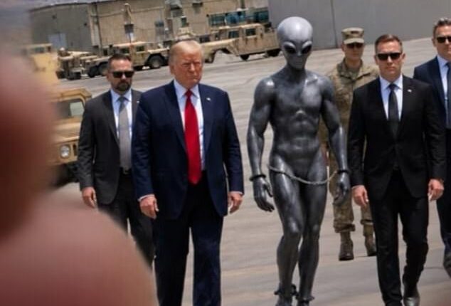 The President and bodyguards flank the handcuffed extra terrestrial at a US military base, in the image posted on Truth Social Sunday