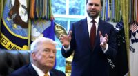 Vice President JD Vance (R) speaks to the media as President Donald Trump looks on during a ceremony in the Oval Office of the White House on March 16