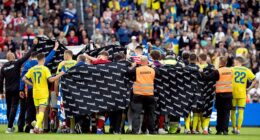 Players and staff shield Denmark's Christian Eriksen after he collapsed again mid-match yesterday