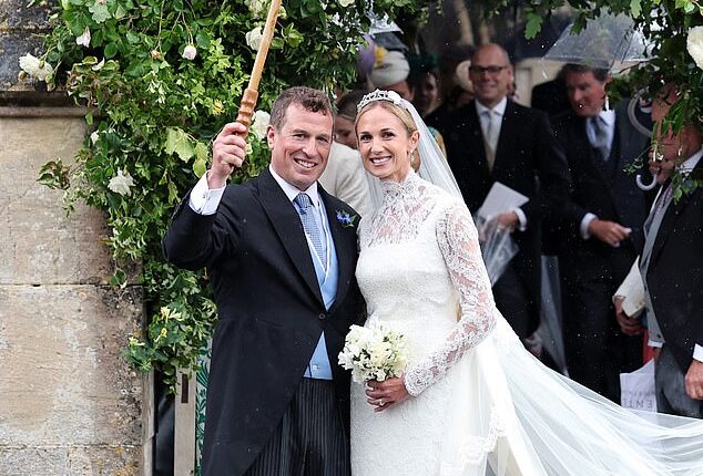The King's nephew Peter Phillips holds an umbrella above his new wife Harriet Sperling