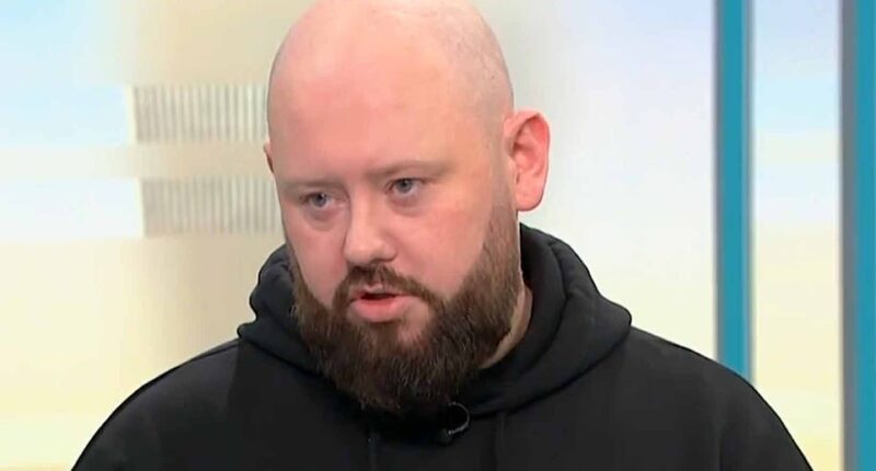 A hero who stopped the alleged knifeman during an attack in Belfast has said intervening was his 'natural reaction' as he condemned rioters and said money raised to support him should go to the victim instead. Maitiu Mág Tighearnán, 32, was seen hitting a man with a hurling stick in a viral video of the assault which left Stephen Ogilvie in a critical condition in hospital. Mr Ogilvie lost his left eye following the attack and suffered injuries to his back, neck and face - including to his right eye - in the attempted 'beheading' at around 10.30pm on Monday. He remains in hospital. Sudanese asylum seeker Hadi Alodid, 30, has since been charged with attempted murder and remanded in custody. The attack on Kinnaird Avenue in the north of the city has led to two nights of anti-immigration rioting in Belfast that has seen homes torched, police officers injured and vehicles set on fire. Speaking to Good Morning Britain this morning, Mr Tighearnán hit out at those bringing violence to the city, saying they have 'lost sight' of what they are protesting for.