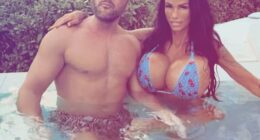 Bikini-clad Katie Price draped herself over Lee Andrews and brandrf them Britain's 'most hated people' - after her husband was accused of scamming 'vulnerable woman' out of £5k