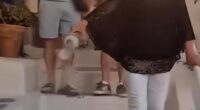 Footage shared to social media showed the woman carrying a clear plastic container filled with what appears to be ash through the picturesque streets of Oia